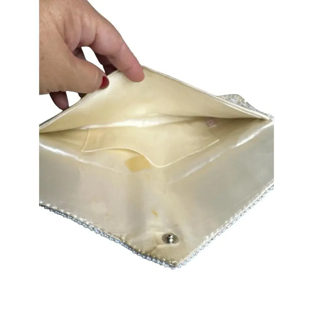 Clutch white size 9”x4” has some stains